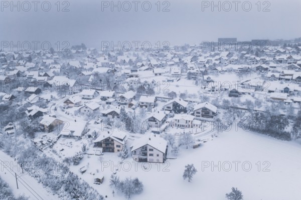 A village in winter rest, the houses are surrounded by snow and fog, Schopfloch, Freudenstadt district, Germany