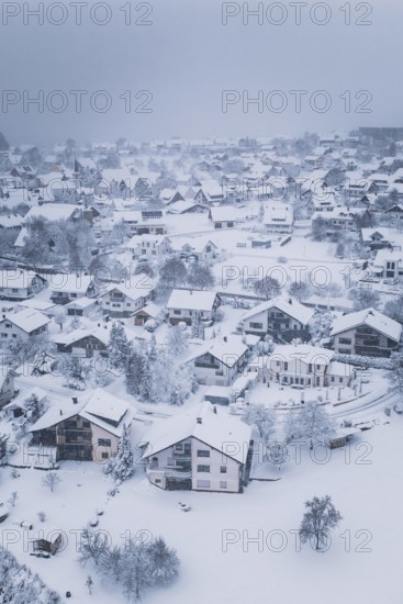 Snowy village with houses and trees, surrounded by winter silence and cold, Schopfloch, Freudenstadt district, Germany