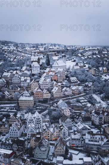 Snow-covered town with numerous half-timbered houses and a distinctive church, Altensteig, Calw district, Germany