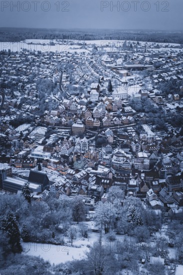 Far-reaching view of a snowy urban landscape with church and houses, Altensteig, Calw district, Germany