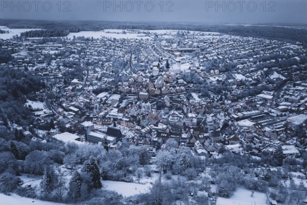 Extensive snow-covered urban area with forests and dense residential areas, Altensteig, Calw district, Germany