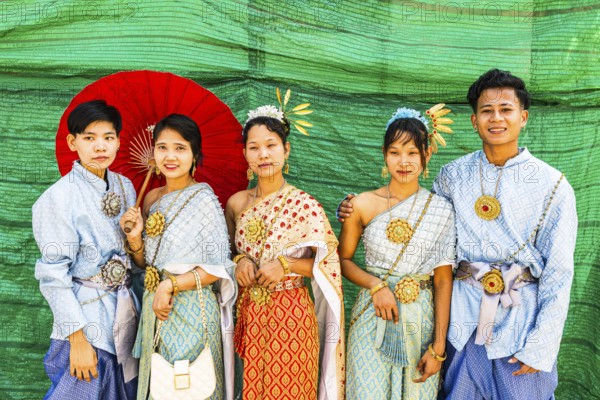 A group of young people wearing traditional clothing presents themselves for the photographers, Wat Arun Buddhist temple, Bangkok, Thailand's metropolis, Thailand