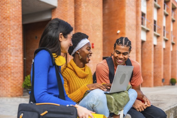 Group of diverse university students smiling and interacting outdoors, using a laptop, representing concepts of education, friendship, and collaborative learning on campus