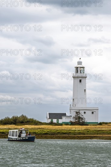 Boats over Hurst Point Lighthouse and Hurst Castle, Hurst Spit, Milford on Sea, Lymington, Hampshire, UK