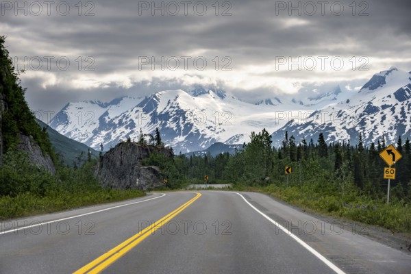 Road through mountain landscape, picturesque landscape with Worthington glacier, dramatic cloudy sky, Richardson Highway, Alaska, USA