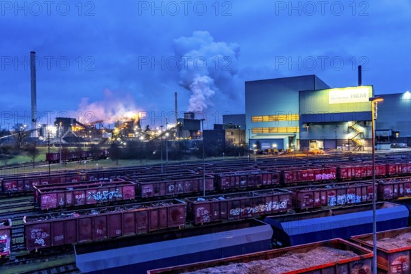 Hüttenwerke Krupp-Mannesmann, HKM in Duisburg, houses of the blast steel plant, coking plant, extinguishing tower with fire cloud, marshalling yard tracks, freight wagon with scrap metal, for melting down, North Rhine-Westphalia, Germany