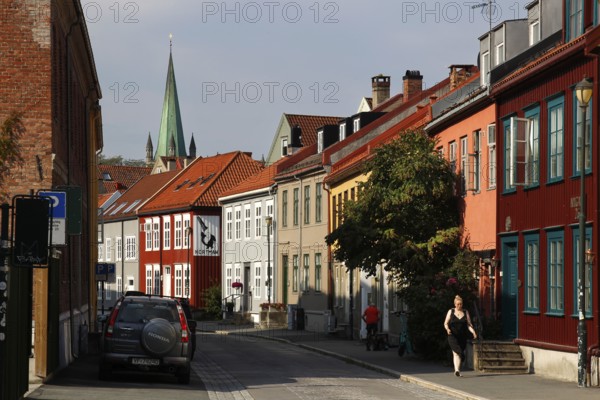 Colourful street scene with wooden houses and church tower, Trondheim, Trøndelag, Norway