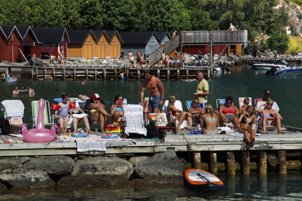 Hustle and bustle at the jetty with sunny relaxation seekers, Solvorn, Norway