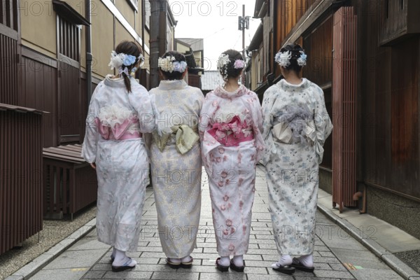 Four woman in kimonos walk through Nakamachi Street in Gion, Gion, Kyoto, Japan