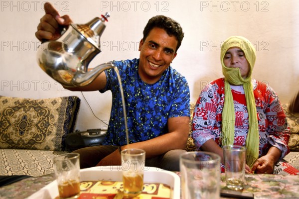 Traditional Moroccan tea ceremony with a man pouring tea, Errachidia, Morocco