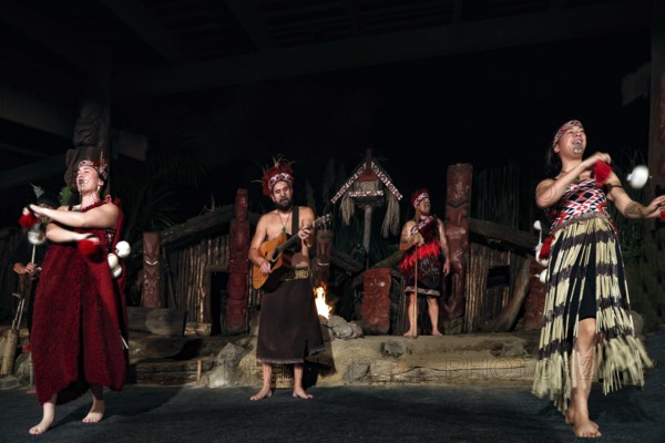 Group of Maori wearing traditional dress at a dance performance on stage in Rotorua, Rotorua, Bay of Plenty, New Zealand