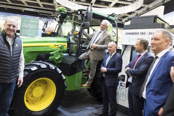 Alios Rainer (Federal Minister of Agriculture, Food and Home Affairs) and Kai Wegner (Governing Mayor of Berlin) in front of an electric John Deere E-Power prototype tractor during the opening tour of the Green Week at the exhibition grounds in Berlin on 16 January 2026. The trade fair for the agricultural and food industry will take place from 16 to 25 January 2026