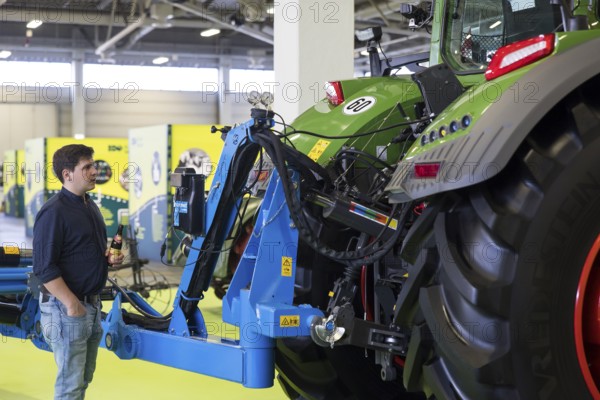 A visitor looks at a tractor as part of the special exhibition on 100 years of Green Week at the exhibition center in Berlin on 16.01.2026. The Agricultural and Food Industry Fair will take place from January 16-25, 2026