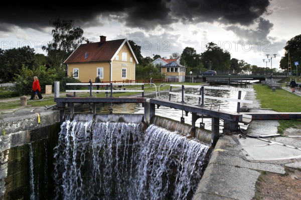 Lock area on Göta Canal in Berg with a picturesque house and dramatic clouds, Berg, Östergötland, Sweden