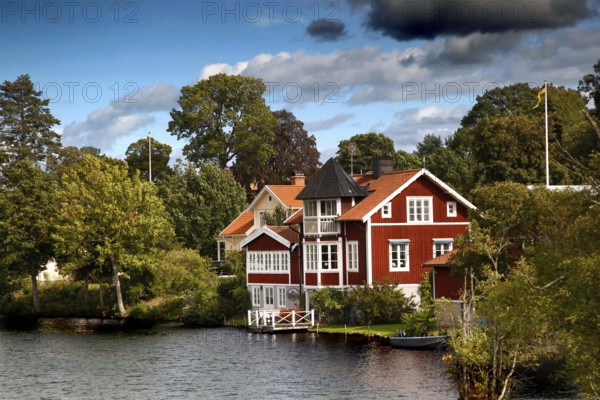 Charming red house on the water of the Göta Canal in Borensberg, surrounded by green nature, Borensberg, Sweden