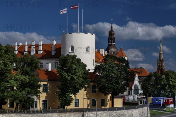 Historic castle with red roof on the Düna in Riga surrounded by trees, Riga, Vidzeme, Latvia
