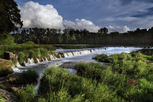 The Ventas Rumba waterfall in Kuldiga with running water and green surroundings, Kuldiga, Courland, Latvia