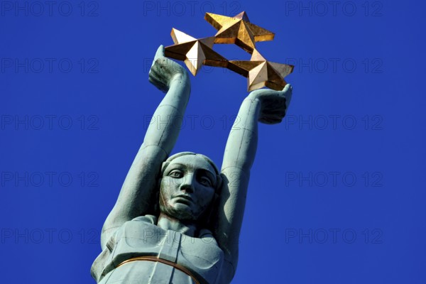 Detail of the Freedom Monument in Riga with three stars against blue sky, Riga, Vidzeme, Latvia
