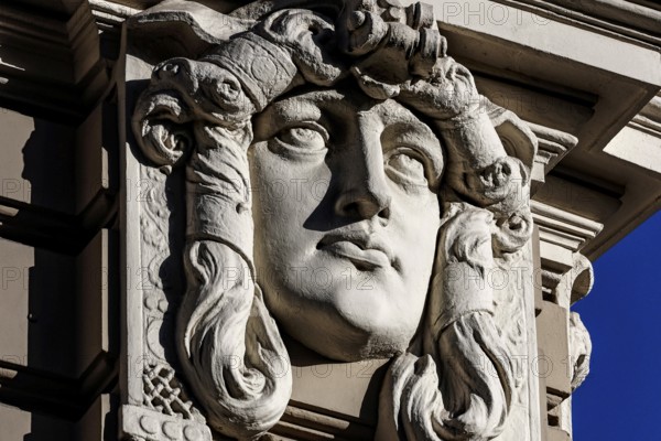 Detail of an Art Nouveau building on Elizabeth Street with a distinctive stone head, Riga, Vidzeme, Latvia