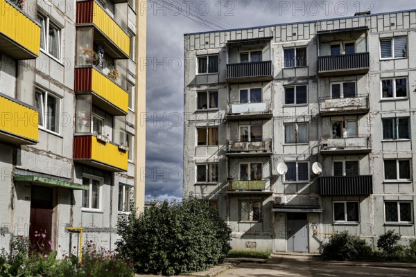 Two-tone prefabricated building with colorful balconies and clouds in the sky, Liepaja, Karosta, Latvia