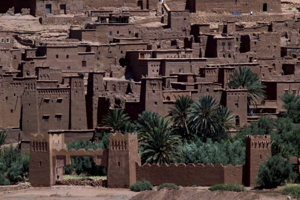 Ait Benhaddou with palm trees in front of the impressive clay architecture, Ait Benhaddou, Ouarzazate, Morocco