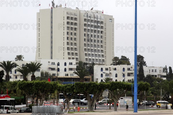 Large modern hotel building surrounded by palm trees and traffic in a city view, Agadir, zero, Morocco