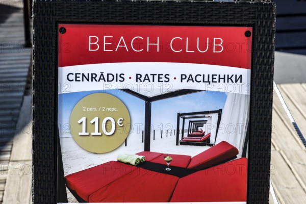 Beach club price table with information in several languages, Majori, Jurmala, Latvia
