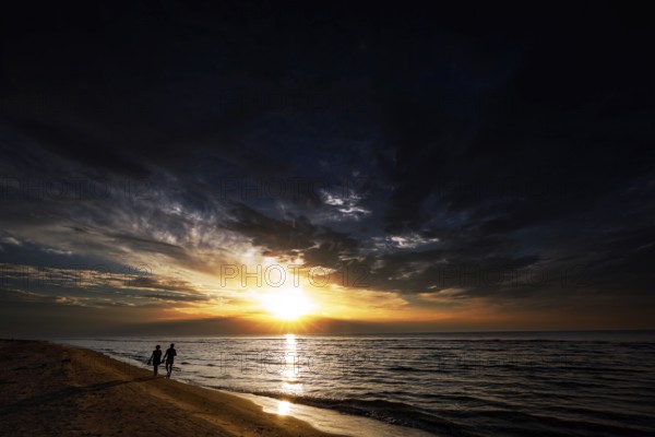Sunset on Kolka beach with walkers on the shore, Kolka, Latvia