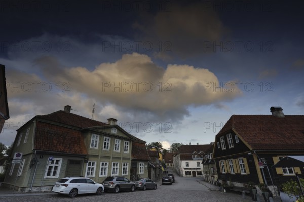 Kuldiga Town Hall Square, Rathausplatz, Rathausplatz with historic buildings and parked cars at dusk, Kuldiga, Courland, Latvia