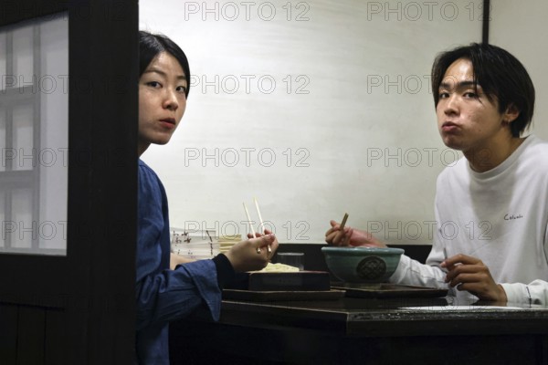 A couple enjoying a meal at a restaurant in Kurashiki, lost deep in thought, Kurashiki, Japan