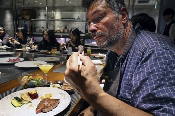 Guest enjoying Kobe steak at Kobe Plaisir restaurant, Kobe, Japan