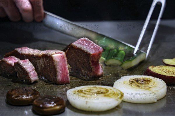 Kobe beef is cut teppanyaki style in restaurant, Kobe, Japan