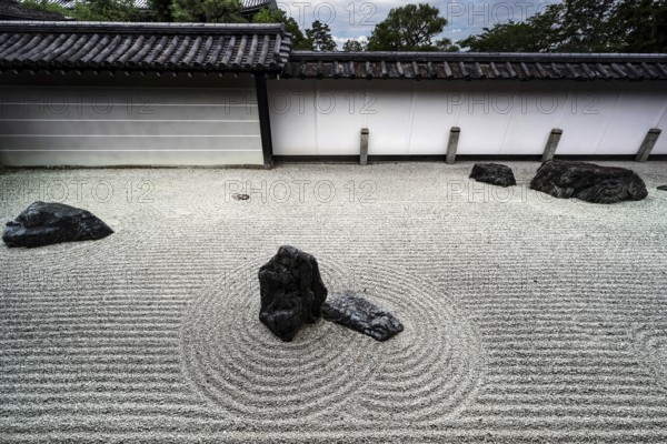 Minimalist zen garden with ornate sand patterns and rock groups, inviting meditation, Kyoto, Japan