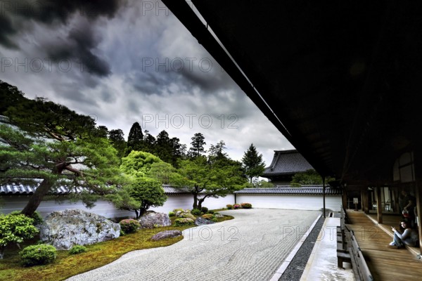 Tora Yaku no Niwa Zen Garden with carefully arranged rocks and sand patterns surrounded by nature, Kyoto, Japan
