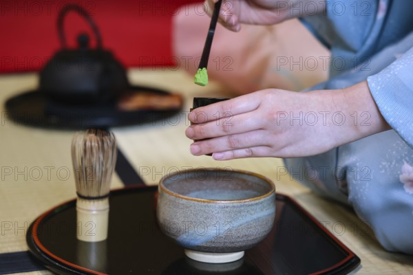 Tea master at a traditional matcha tea ceremony with utensils, Kyoto, Higashiyama, Japan