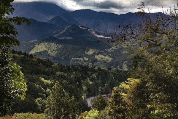Lush valleys and forests stretch under a cloudy sky, Kiso, Nagano, Japan