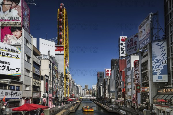Dotonbori area with lively atmosphere, colorful billboards along the river, Osaka, Namba, Japan