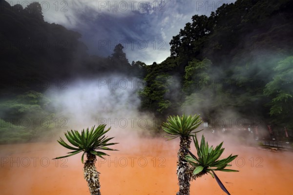 Steam rises over the red water of Chinoike Jigoku in Beppu, Beppu, Kyushu, Japan