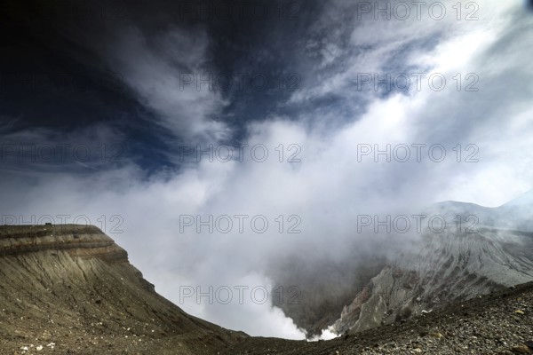 Nakadake crater in morning light with dramatic clouds and geological contrasts, Aso, Kumamoto, Japan