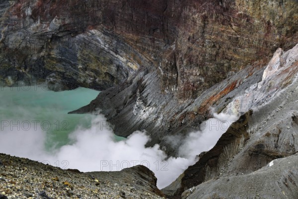 Steaming crater lake with color-varying rock structures, Aso, Kumamoto, Japan