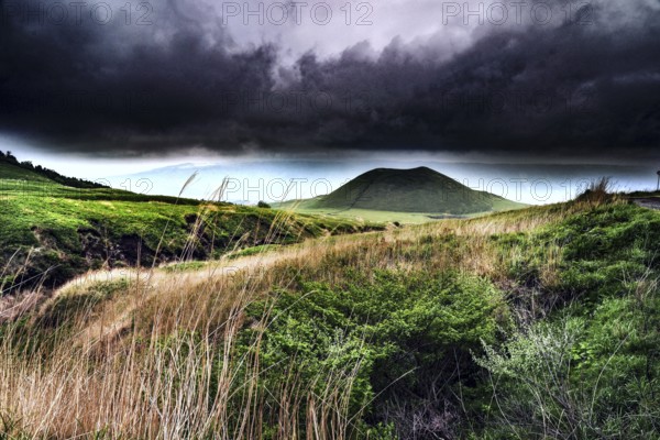 Dramatic landscape with stormy sky and crater hills, Aso, Japan