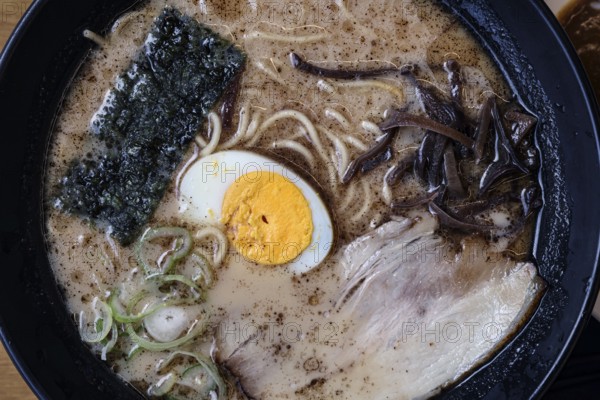 Bowl of ramen with egg and seaweed in a restaurant in Aso, Aso, Japan