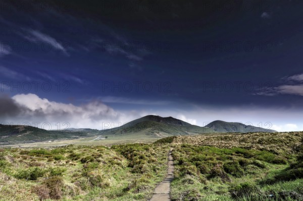 Extensive crater landscape under clear blue sky, Aso, Japan