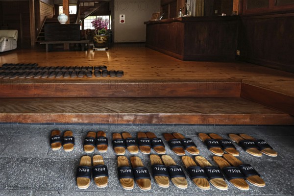 Entrance to Ryokan Minshuku Asogen with carefully arranged shoes