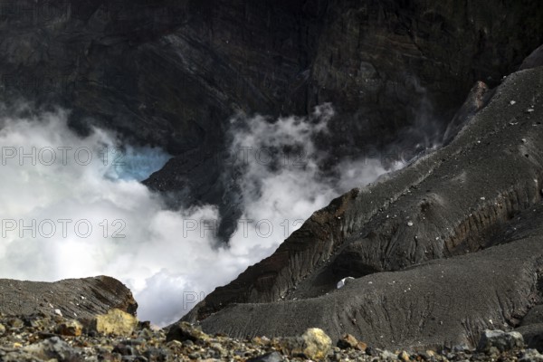 Morning light illuminates Nakadake crater in Aso with rising fog, Aso, Kyushu, Japan