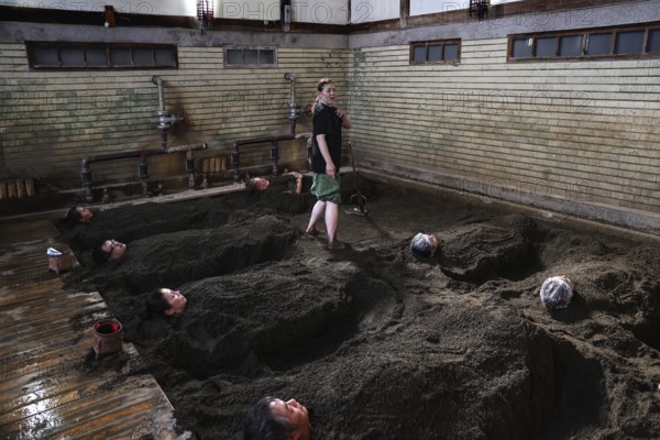 Visitors to Takegawara Onsen are deeply relaxed in sand baths, Beppu, Oita, Japan