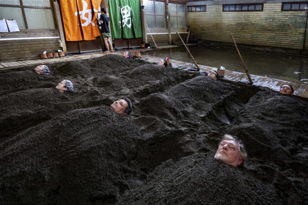 Attendees enjoy a unique sand bath at Takegawara Onsen in Beppu, Beppu, Oita, Japan
