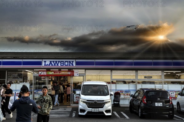 A konbini in Kawaguchi-ko with Mount Fuji in the background at sunset, Kawaguchi-ko, Yamanashi, Japan