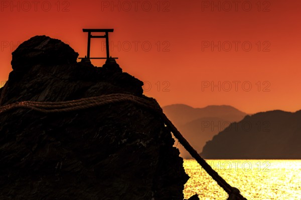 Meoto Iwa silhouette at sunrise with Torii, Ise, Mie, Japan