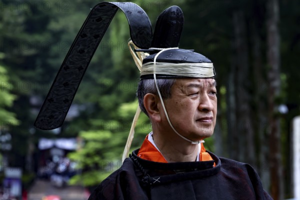 Man wearing traditional clothing and distinctive head covering during a cultural festival in Nikko, Nikko, Tochigi, Japan
